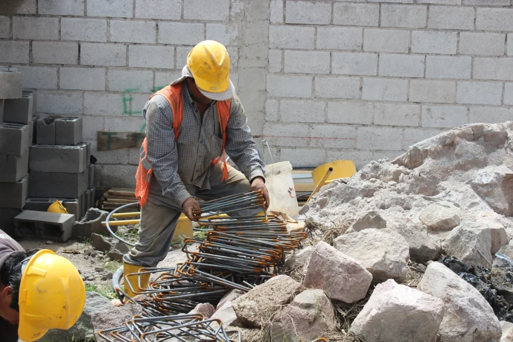 a general contractor stacking rebar on a construction site