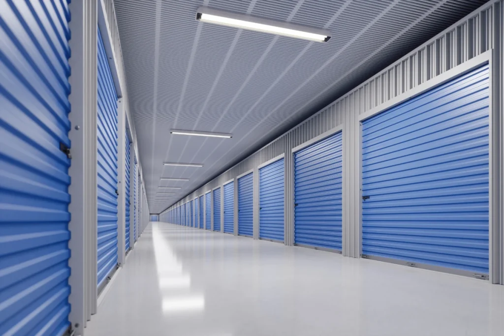 the inside of a brand new self storage development with blue metal doors